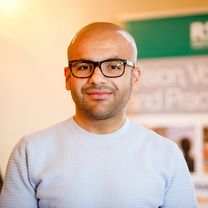 Ali Al-Tuckmachy, a bald man with glasses