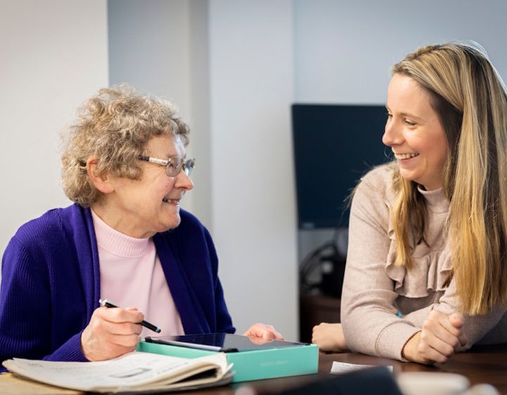 An older woman and a younger woman having a conversation