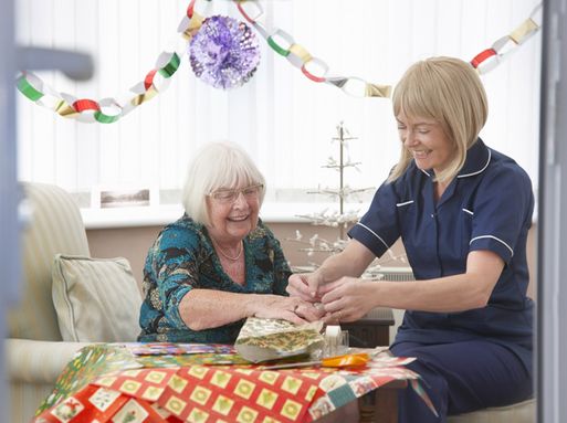 An adult social care nurse celebrating with a patient
