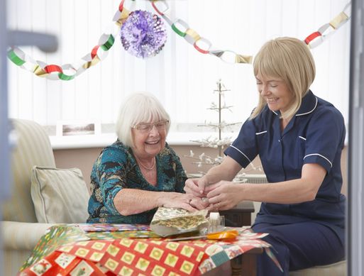 An adult social care nurse celebrating with a patient