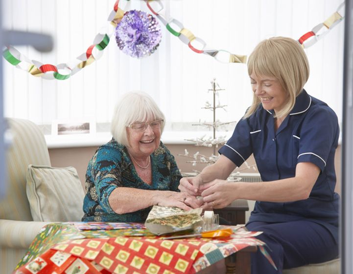 An adult social care nurse celebrating with a patient