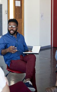 A group of people sat in a circle talking.