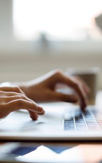A person typing on a laptop