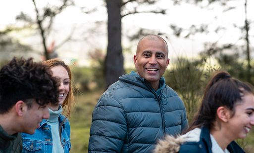 A group of friends going for a walk in a park.