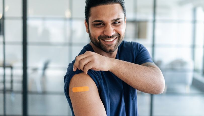 Man showing off his plaster after a vaccina