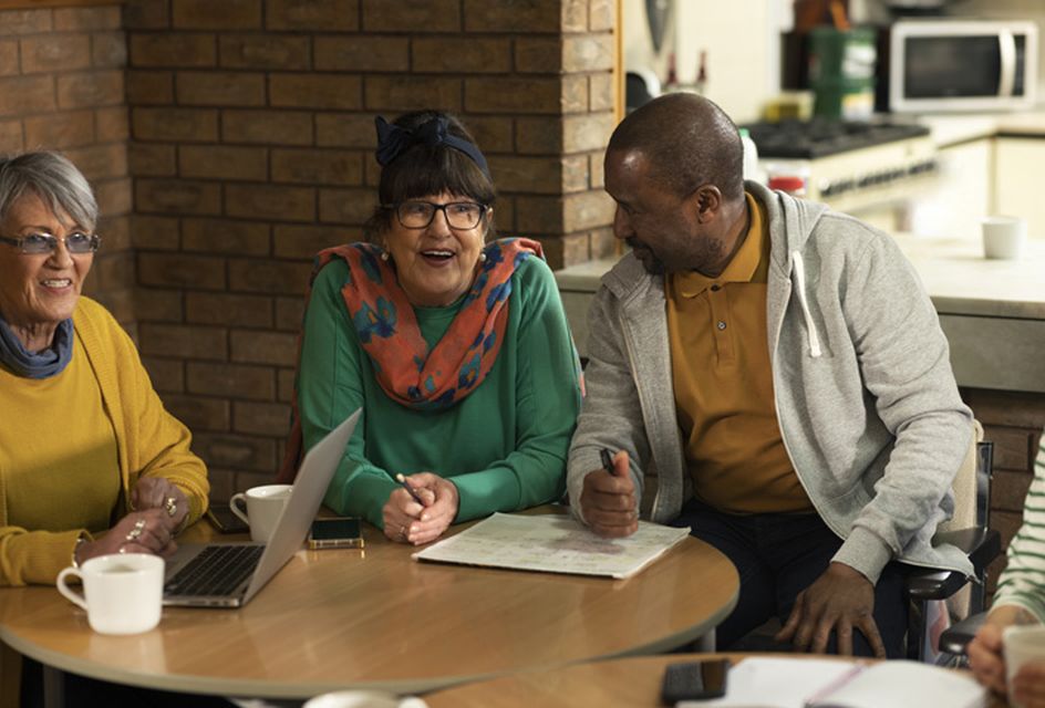 A group of older people having a conversation about mental health