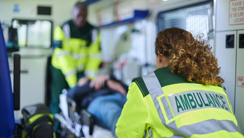 Paramedics loading a patient into an ambulance