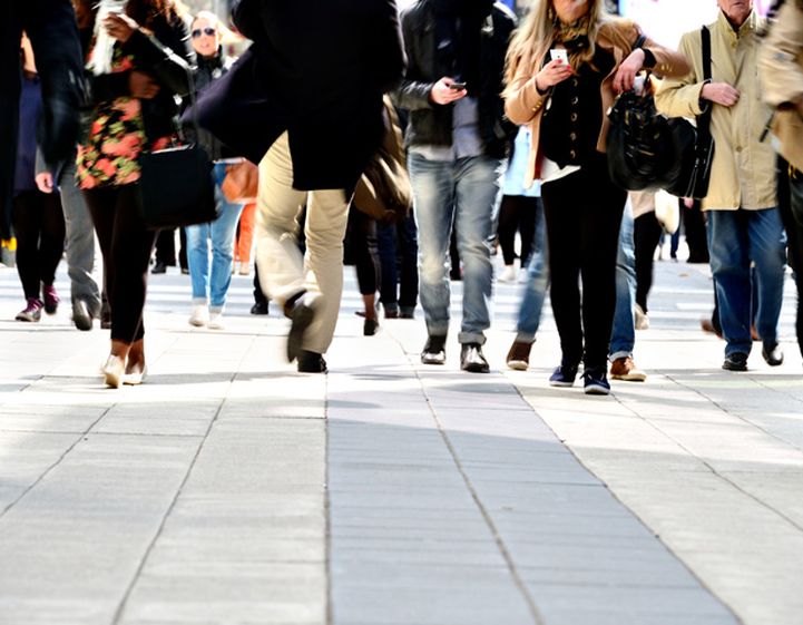 Crowd of people walking along a busy street
