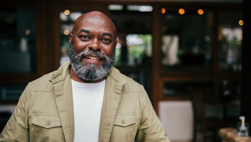 Older man smiling after having a received a vaccination