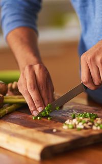 A man chopping ingredients for a healthy meal