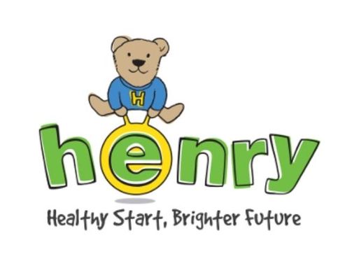A logo showing a cartoon teddy bear wearing a tshirt with a H on sitting on top of green text reading "henry"