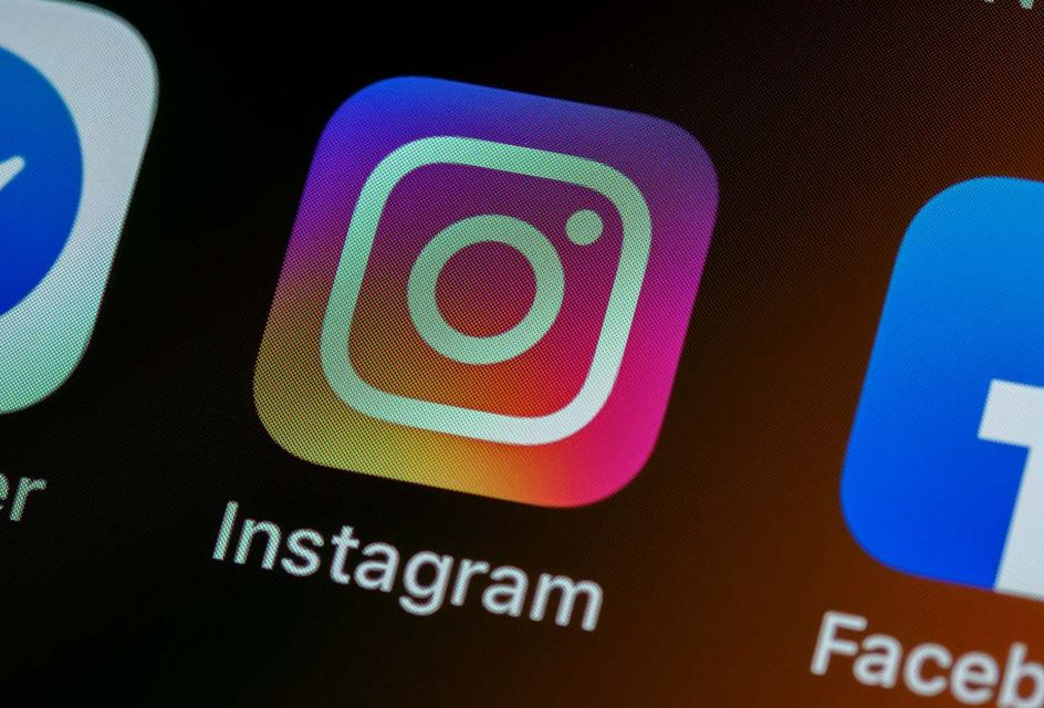 A close-up shot of a phone screen showing the Instagram logo.