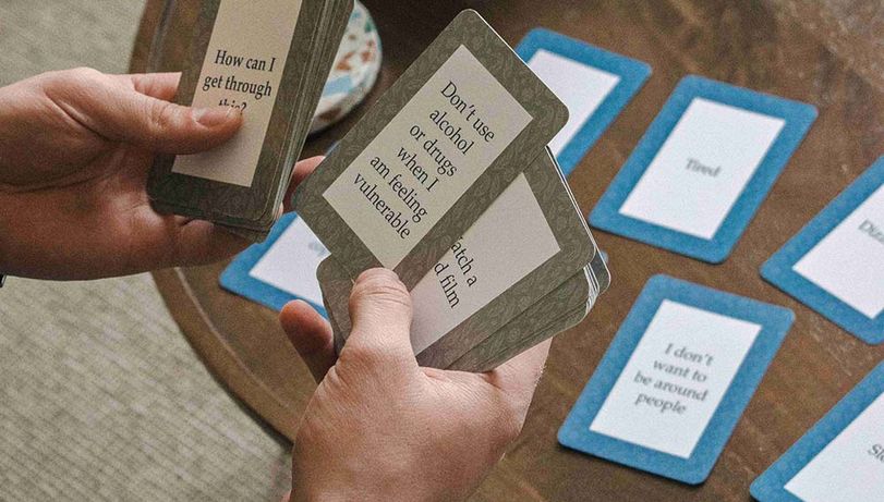 Talking cards used in James' Place therapy sessions. From left to right, the cards read "How can I get through this?" and "Don't use alcohol or drugs when I am feeling vulnerable".