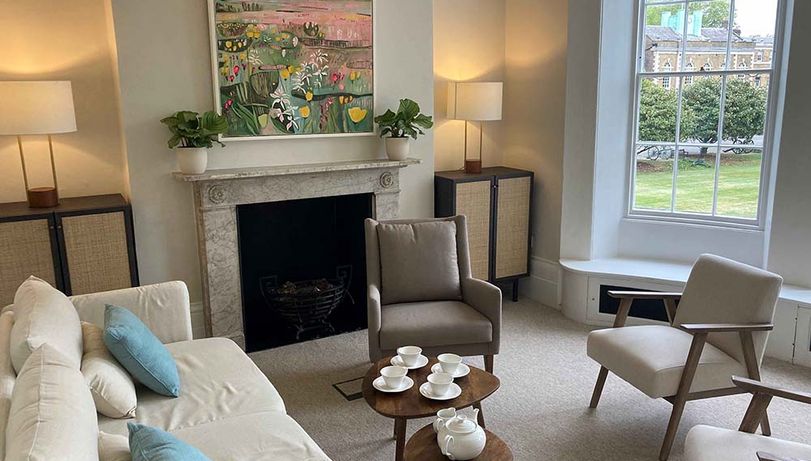 A therapy room at James' Place, with chairs, tables and a fireplace