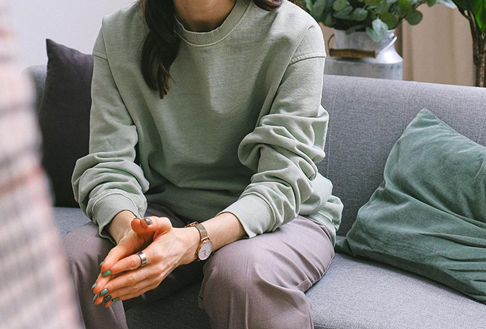 A close up of a woman's hands clasped together.